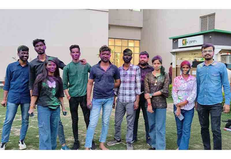 Smiling team with vibrant faces during Holi celebration at Weblytic Labs
