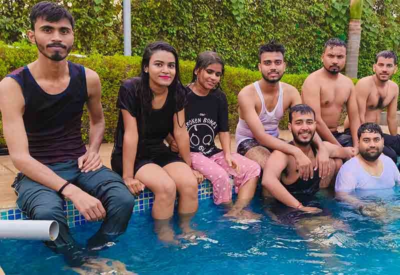 Group photo of Weblytic team enjoying poolside fun and games
